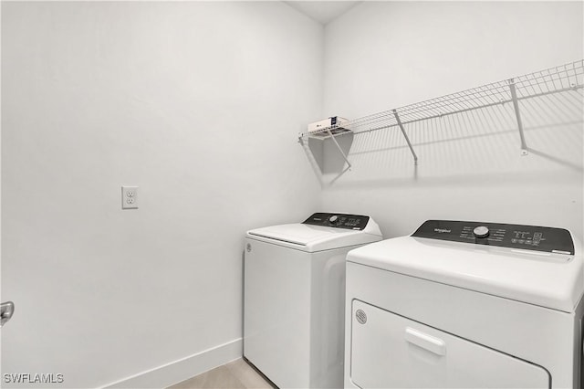 44494 Little Blue Heron Way, Punta Gorda, FL 33982 - laundry area with washer and dryer and baseboards