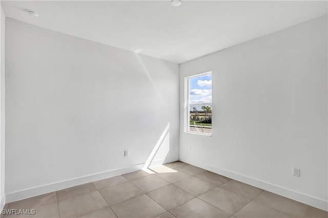 44494 Little Blue Heron Way, Punta Gorda, FL 33982 - spare room featuring baseboards, light tile patterned floors, and a smoke detector