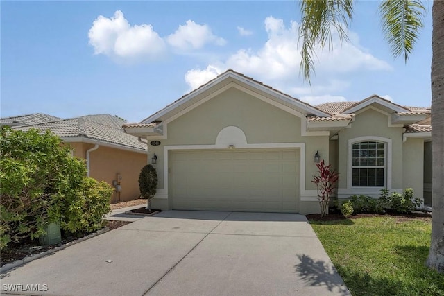 8546 Silk Oak Ln, Naples, FL 34119 - view of front facade with stucco siding, concrete driveway, a garage, a tile roof, and a front lawn