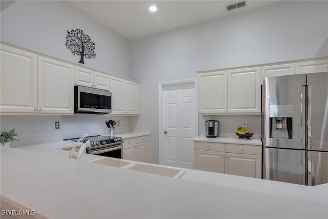 8546 Silk Oak Ln, Naples, FL 34119 - kitchen featuring appliances with stainless steel finishes, light countertops, white cabinetry, and recessed lighting