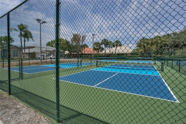 8546 Silk Oak Ln, Naples, FL 34119 - view of tennis court featuring fence