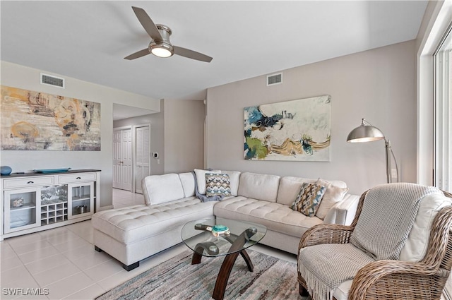 living room featuring ceiling fan and light tile patterned floors
