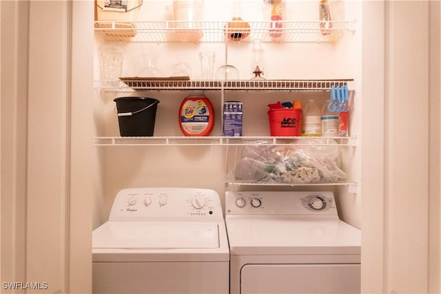 washroom featuring separate washer and dryer and laundry area