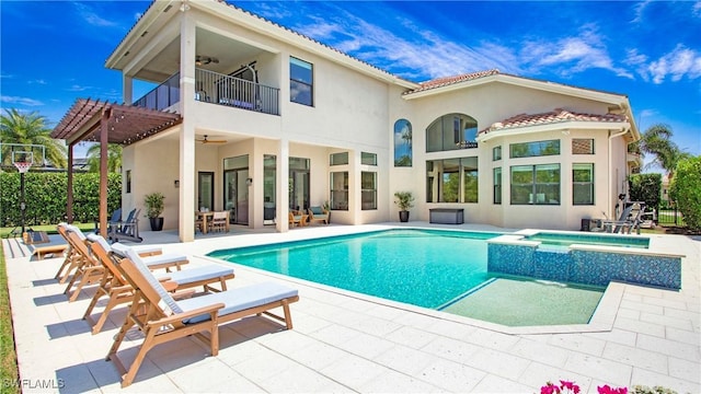 2954 Cinnamon Bay Cir, Naples, FL 34119 - back of house with ceiling fan, a balcony, stucco siding, a pool with connected hot tub, and a patio area