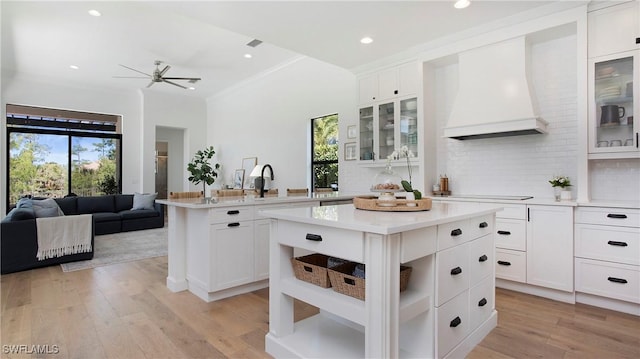 2954 Cinnamon Bay Cir, Naples, FL 34119 - kitchen with premium range hood, ceiling fan, plenty of natural light, a peninsula, and recessed lighting