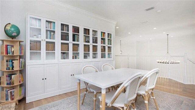 2954 Cinnamon Bay Cir, Naples, FL 34119 - dining room with light wood finished floors, a chandelier, recessed lighting, and ornamental molding
