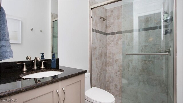 2954 Cinnamon Bay Cir, Naples, FL 34119 - bathroom with a stall shower, vanity, and toilet