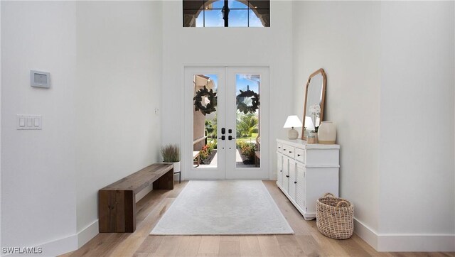 2954 Cinnamon Bay Cir, Naples, FL 34119 - foyer entrance with french doors, light wood-style floors, a high ceiling, and baseboards