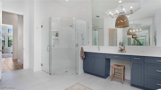 2954 Cinnamon Bay Cir, Naples, FL 34119 - full bathroom featuring a chandelier, vanity, and a shower stall
