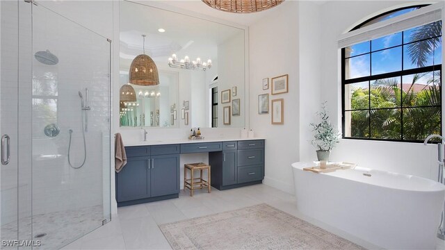 2954 Cinnamon Bay Cir, Naples, FL 34119 - full bathroom featuring a shower stall, vanity, a chandelier, a freestanding bath, and baseboards