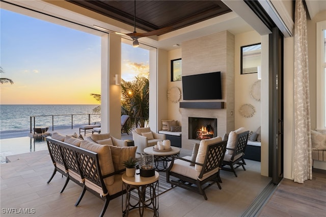 26924 Hickory Blvd, Bonita Springs, FL 34134 - patio terrace at dusk with an outdoor living space with a fireplace and a water view