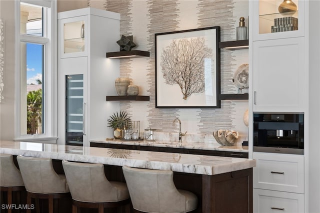 26924 Hickory Blvd, Bonita Springs, FL 34134 - indoor wet bar with black oven and backsplash