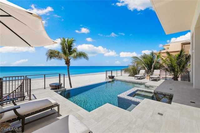 26924 Hickory Blvd, Bonita Springs, FL 34134 - view of pool featuring view of water and beach, a patio area, and a pool with connected hot tub