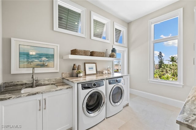 26924 Hickory Blvd, Bonita Springs, FL 34134 - washroom with washing machine and clothes dryer, baseboards, and plenty of natural light