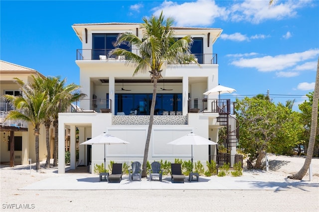 26924 Hickory Blvd, Bonita Springs, FL 34134 - view of front of house featuring a balcony, stairs, and stucco siding