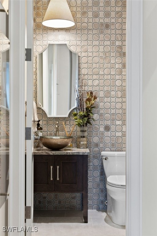 26924 Hickory Blvd, Bonita Springs, FL 34134 - bathroom featuring toilet, vanity, and tile patterned flooring