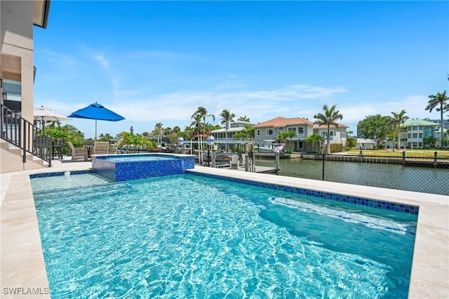 388 Pine Ave, Naples, FL 34108 - view of pool featuring a pool with connected hot tub, a water view, and a patio area
