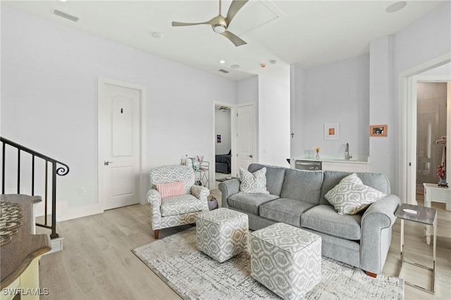 388 Pine Ave, Naples, FL 34108 - living room with ceiling fan, light wood-style floors, and stairs