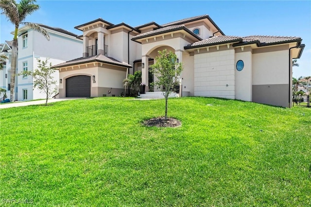 388 Pine Ave, Naples, FL 34108 - mediterranean / spanish-style home with a front yard, stucco siding, a tile roof, and driveway