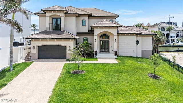388 Pine Ave, Naples, FL 34108 - mediterranean / spanish-style home with stucco siding, french doors, a garage, and decorative driveway