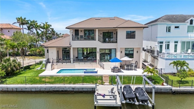 388 Pine Ave, Naples, FL 34108 - rear view of house featuring a balcony, stucco siding, a patio area, a water view, and a tiled roof