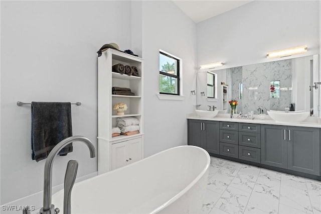 388 Pine Ave, Naples, FL 34108 - bathroom featuring marble look tiles, double vanity, a soaking tub, and walk in shower