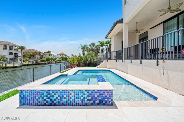 388 Pine Ave, Naples, FL 34108 - view of pool featuring a ceiling fan, a water view, and a pool with connected hot tub