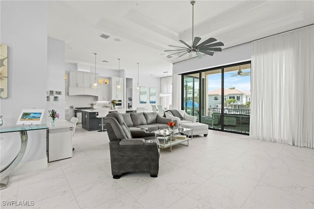 388 Pine Ave, Naples, FL 34108 - living area featuring a ceiling fan and light marble finish floors