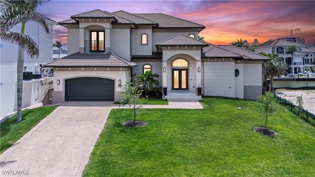 388 Pine Ave, Naples, FL 34108 - mediterranean / spanish-style house featuring french doors, stucco siding, decorative driveway, and a tile roof