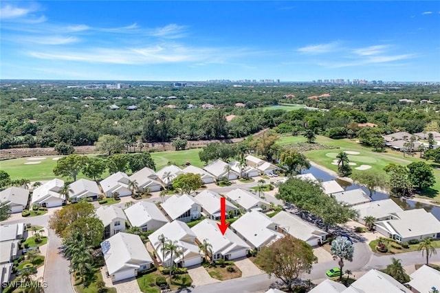 aerial view of residential area with a golf club and a tree filled landscape