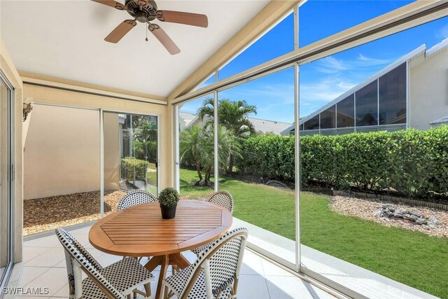 sunroom featuring a ceiling fan and vaulted ceiling