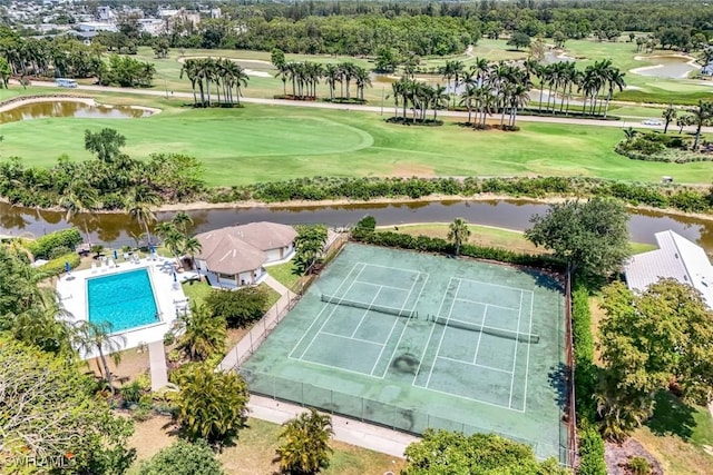 bird's eye view of a golf club, a large body of water, and a pool