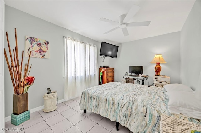 bedroom featuring light tile patterned floors, baseboards, and ceiling fan