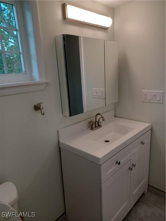 bathroom featuring vanity and toilet