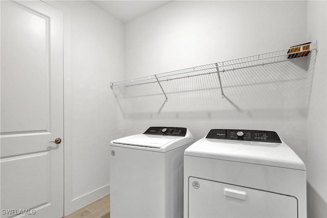 44287 Panther Dr, Punta Gorda, FL 33982 - laundry area with washing machine and dryer, wood finished floors, and baseboards