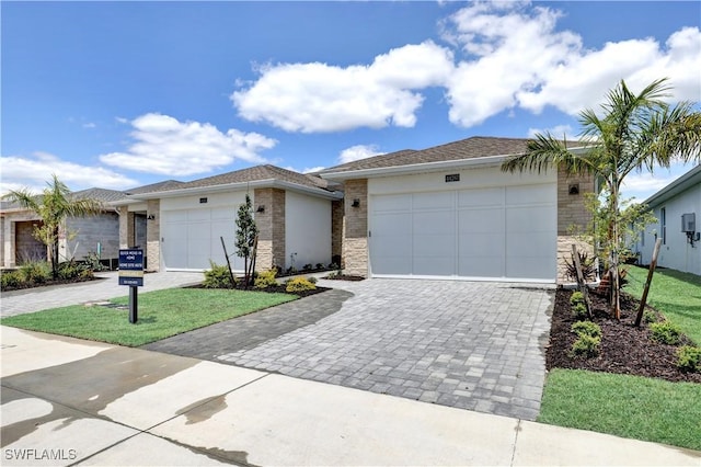 44287 Panther Dr, Punta Gorda, FL 33982 - view of front facade with an attached garage, decorative driveway, a front yard, and brick siding