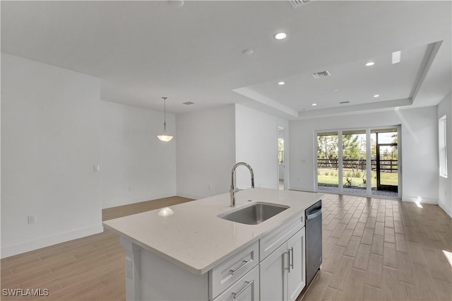 44287 Panther Dr, Punta Gorda, FL 33982 - kitchen with a sink, open floor plan, dishwasher, a tray ceiling, and light wood finished floors