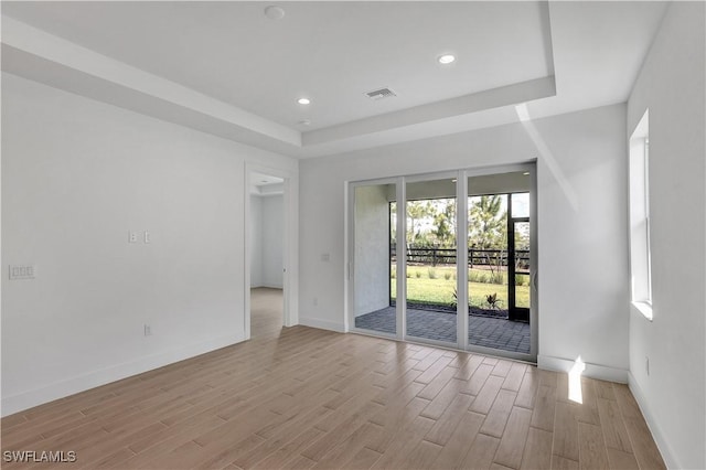 44287 Panther Dr, Punta Gorda, FL 33982 - spare room featuring a tray ceiling, light wood-style flooring, baseboards, and recessed lighting