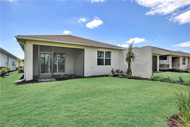 44287 Panther Dr, Punta Gorda, FL 33982 - back of property with stucco siding, a yard, and a sunroom