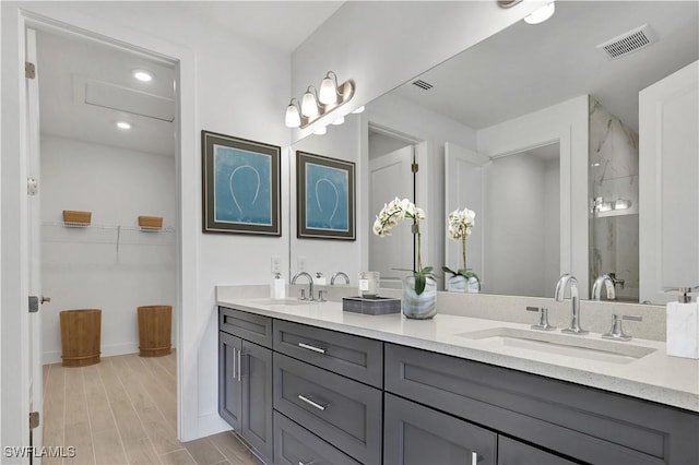 44287 Panther Dr, Punta Gorda, FL 33982 - full bathroom featuring double vanity, baseboards, wood finished floors, tiled shower, and recessed lighting