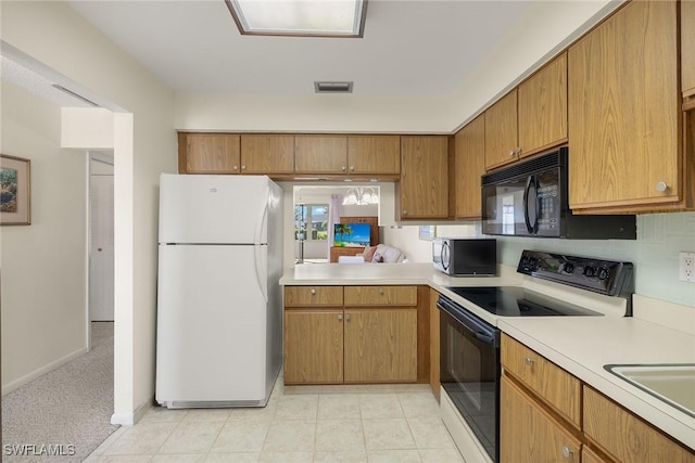 6861 Bogey Dr, Fort Myers, FL 33919 - kitchen featuring freestanding refrigerator, range with electric cooktop, light countertops, and stainless steel microwave