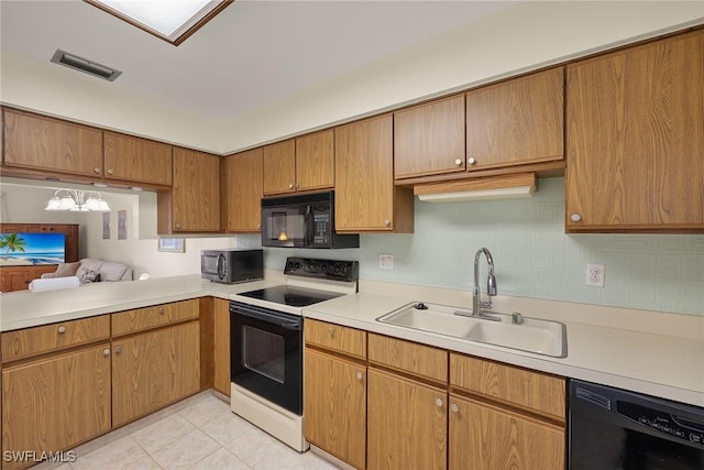 6861 Bogey Dr, Fort Myers, FL 33919 - kitchen with black appliances, a sink, light countertops, tasteful backsplash, and light tile patterned flooring