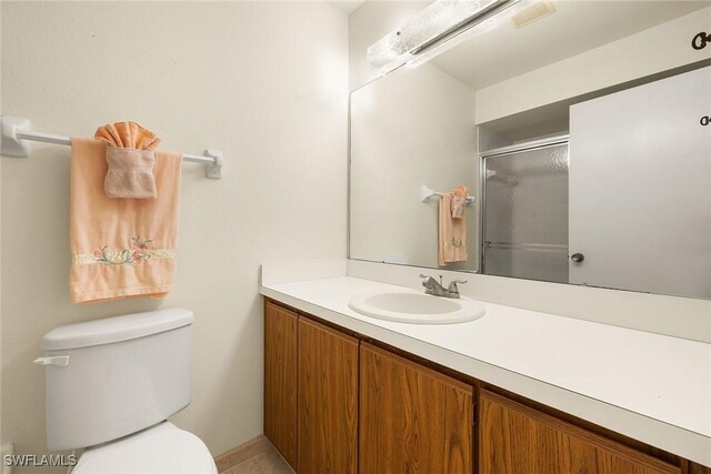 6861 Bogey Dr, Fort Myers, FL 33919 - full bathroom with toilet, vanity, and a shower with door