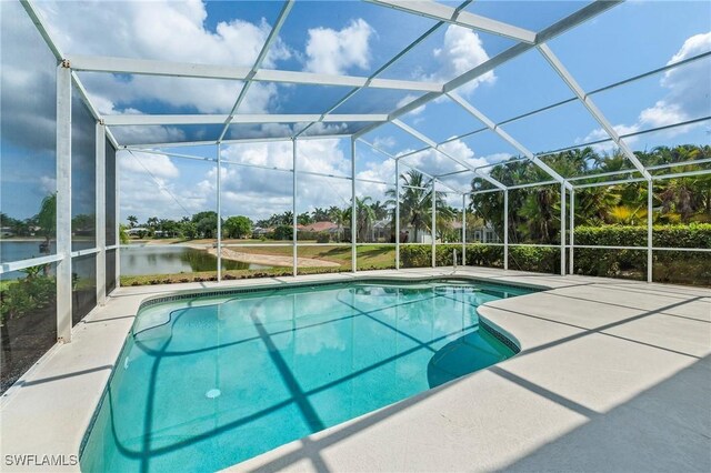 1526 Vintage Ln, Naples, FL 34104 - swimming pool featuring a water view, a patio area, and a lanai