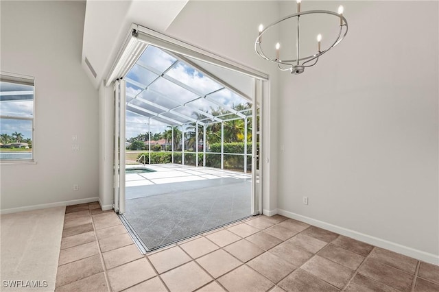 1526 Vintage Ln, Naples, FL 34104 - doorway to outside featuring a chandelier, plenty of natural light, light tile patterned floors, and a sunroom