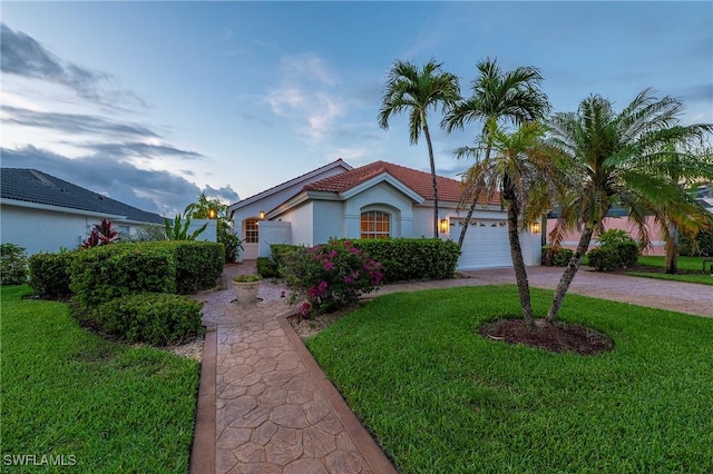 1526 Vintage Ln, Naples, FL 34104 - mediterranean / spanish-style home featuring a front lawn, stucco siding, driveway, and a garage
