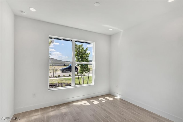 44512 Little Blue Heron Way, Punta Gorda, FL 33982 - empty room with baseboards, wood finished floors, and recessed lighting