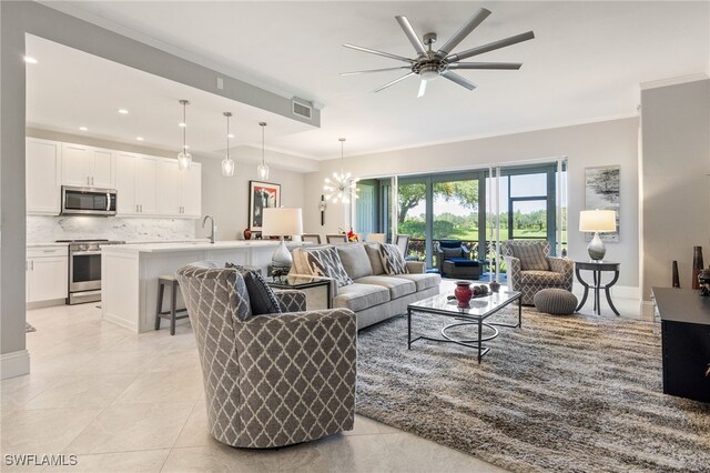 9380 Triana Ter Unit 312, Fort Myers, FL 33912 - living area with crown molding, ceiling fan, light tile patterned floors, recessed lighting, and a chandelier