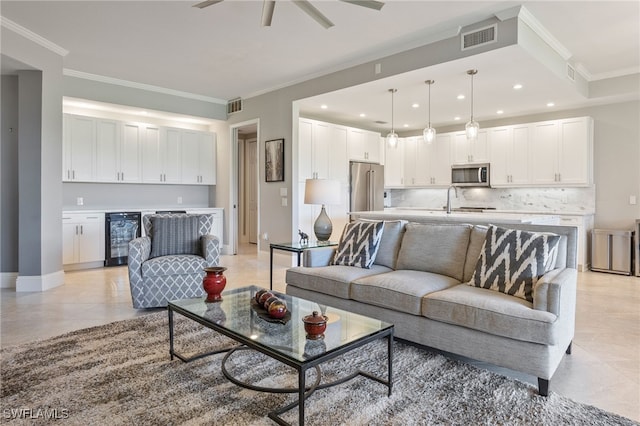 9380 Triana Ter Unit 312, Fort Myers, FL 33912 - living room with beverage cooler, ornamental molding, ceiling fan, light tile patterned floors, and recessed lighting
