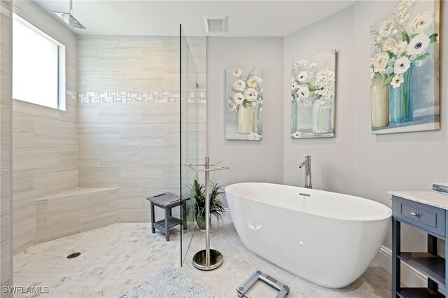 9380 Triana Ter Unit 312, Fort Myers, FL 33912 - bathroom with a freestanding tub, a walk in shower, and baseboards